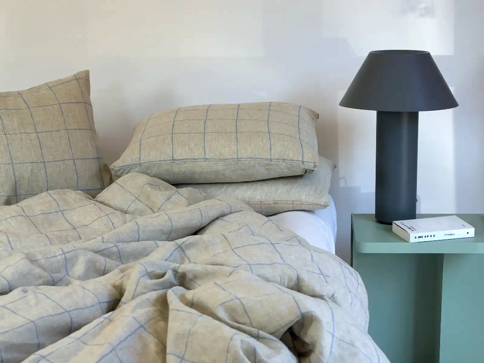 Polish designer bedding in natural linen tones in a modern bedroom